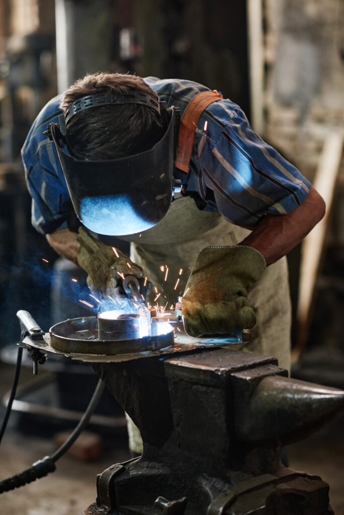 Industrial welder working with torch