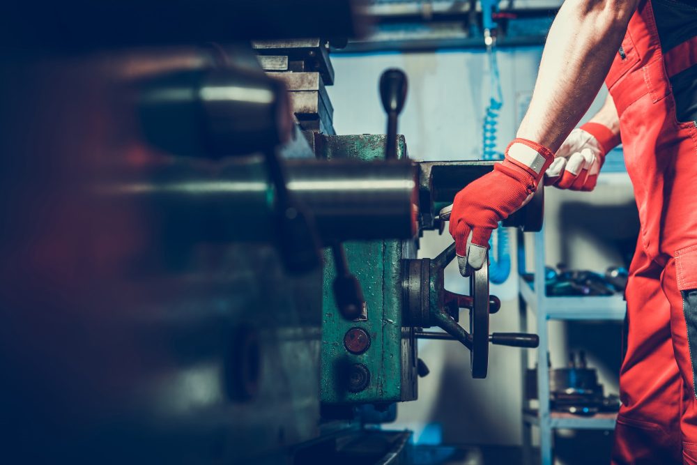 Caucasian Lathe Machine Technician During Metal Boring Process